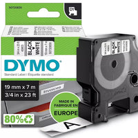 Dymo white plastic label refill tape in its original retail blister packaging, featuring a black tape roll inside a clear plastic casing on a green and white card backing.