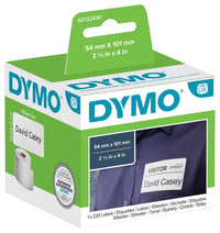 Dymo white plastic label refill tape in its original retail blister packaging, featuring a black tape roll inside a clear plastic casing on a green and white card backing.