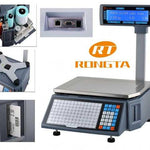 A digital scale with a blue weighing platform, a black and gray control panel with a numeric keypad, and an overhead display screen showing blue text on a white background.