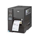 A black TSC industrial barcode label printer with a digital control panel on the left side and a label sheet emerging from the front output slot, shown on a plain white background.