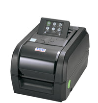 A TSC thermal label printer with a black body, a small front-facing color display screen, and a green power button, shown on a solid white background.