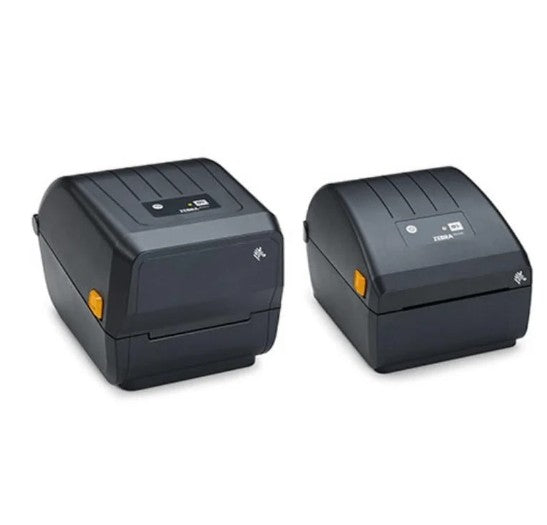 Two black Zebra thermal label printers shown side by side on a plain white background, with one printer displaying a ZEBRA logo on the top panel.