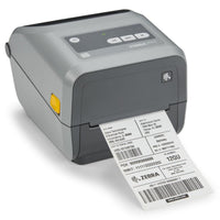 A Zebra QR-ZD421C barcode label printer in dark gray, shown with a white label sheet partially ejected from the front. The printer features a black control panel with a small LCD screen and directional buttons, set against a clean white background.