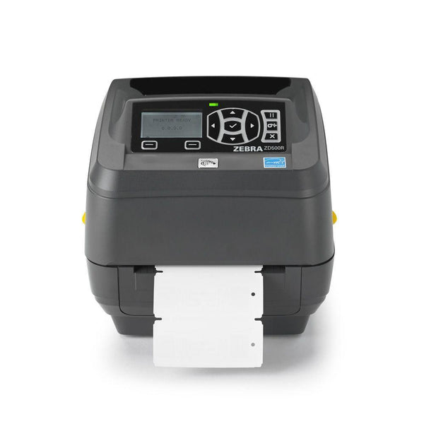 A Zebra QR-ZD500R barcode label printer in dark gray, shown with a white label sheet partially ejected from the front. The printer features a black control panel with a small LCD screen and directional buttons, set against a clean white background.